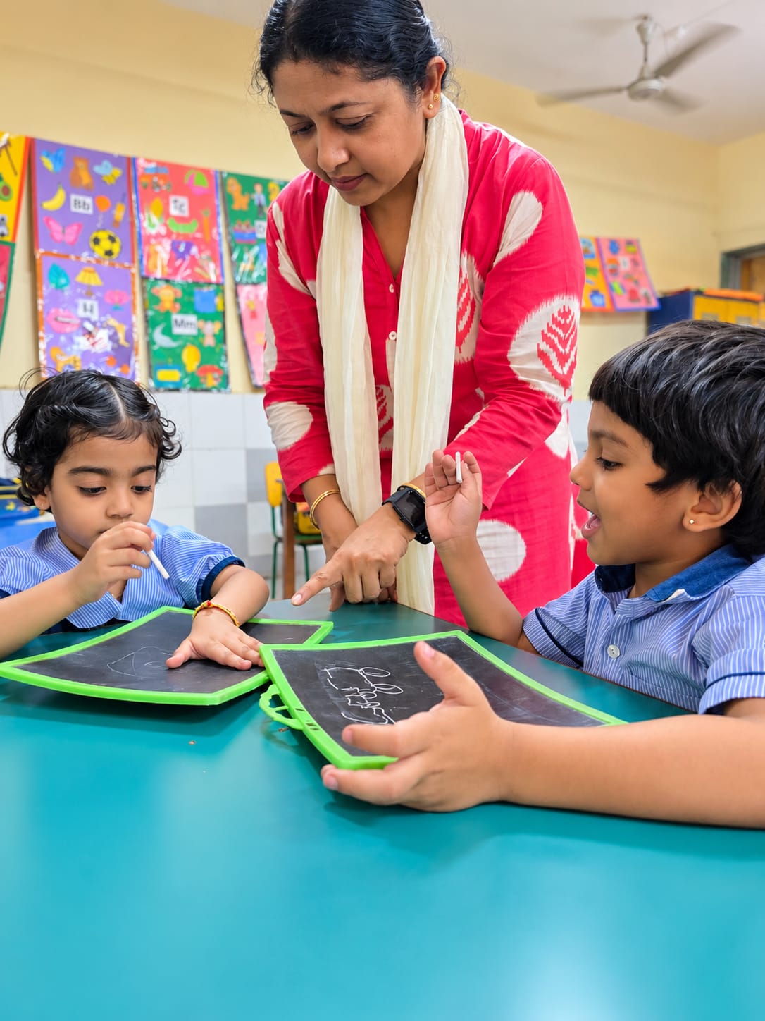 A North Point School teacher guiding Early Years students through a classroom activity